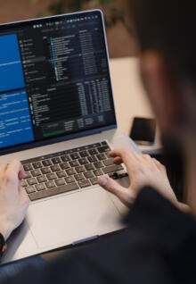 Close up man writing code laptop